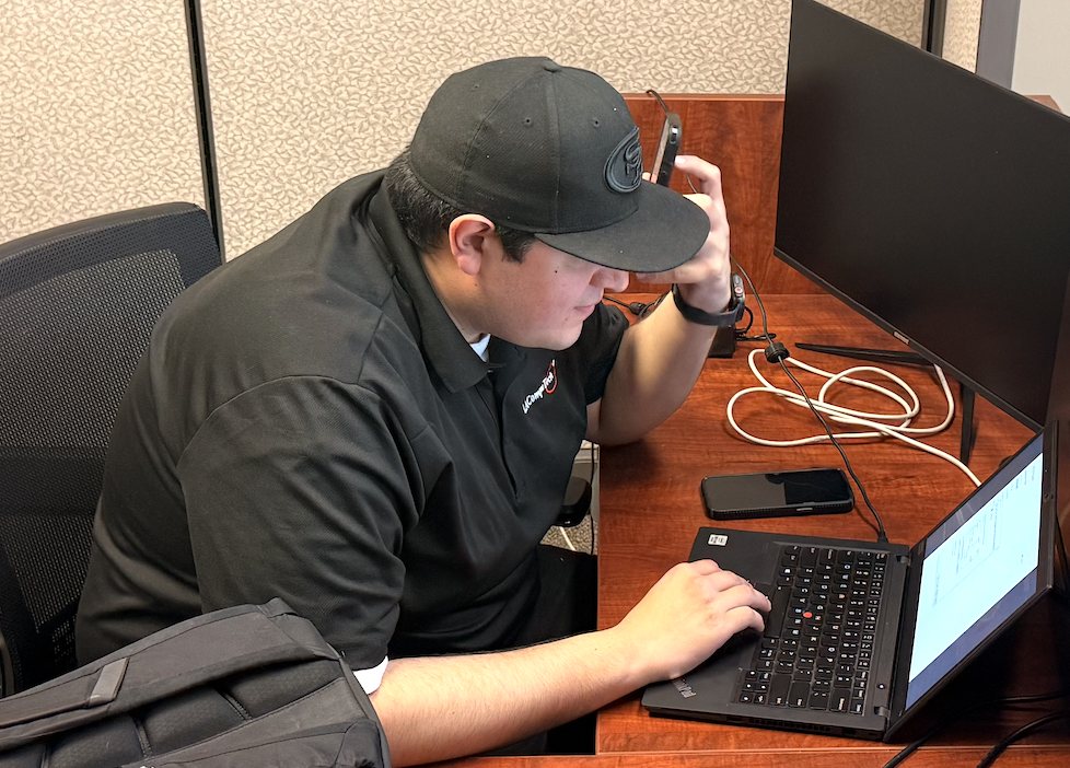 An LAComputech technician working at a managed workstation